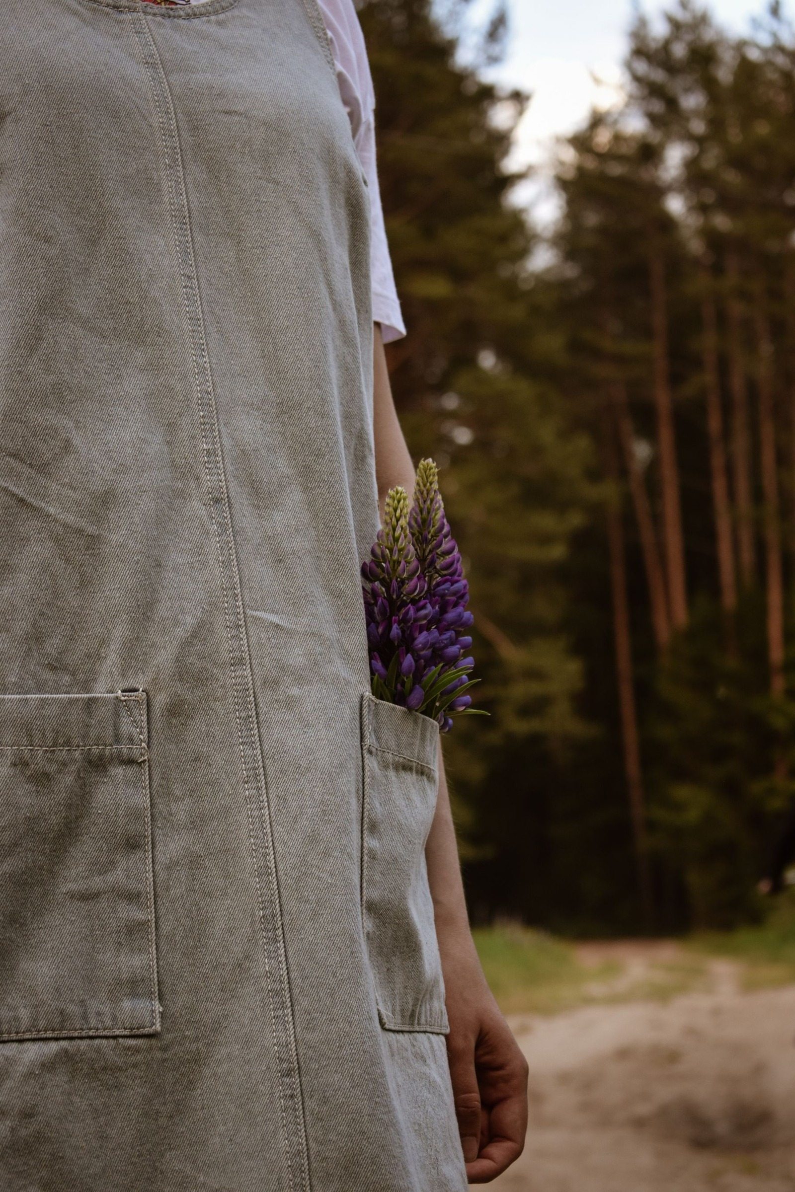 Close-up of lavender flowers tucked into a gray dress pocket