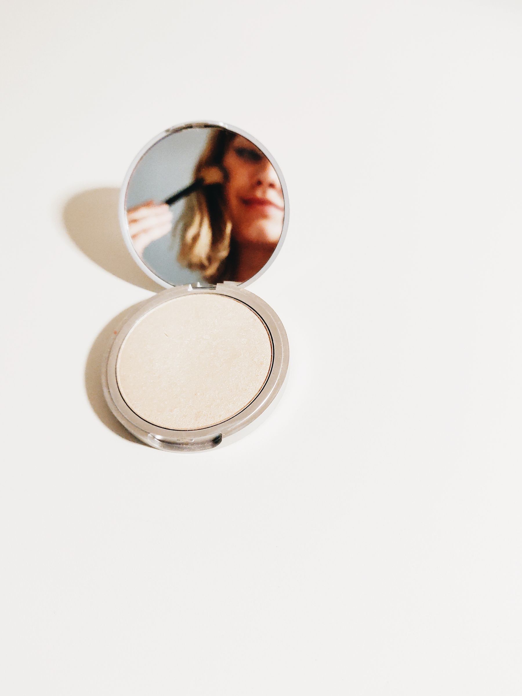 Pressed powder compact on a white surface