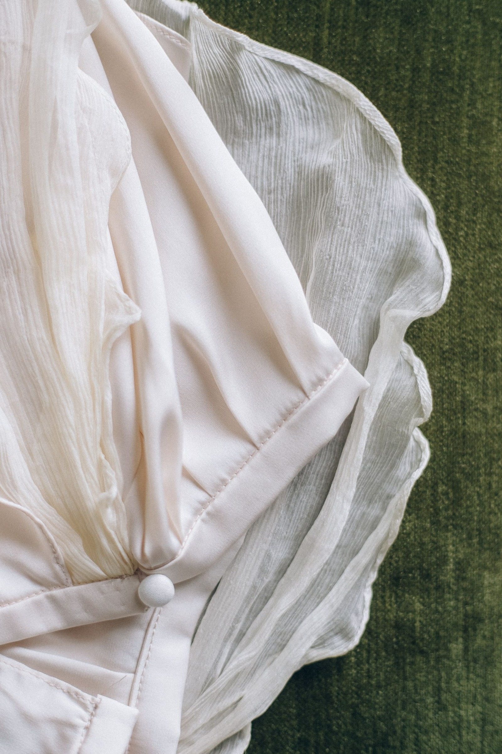 Close-up of pleated white dress fabric