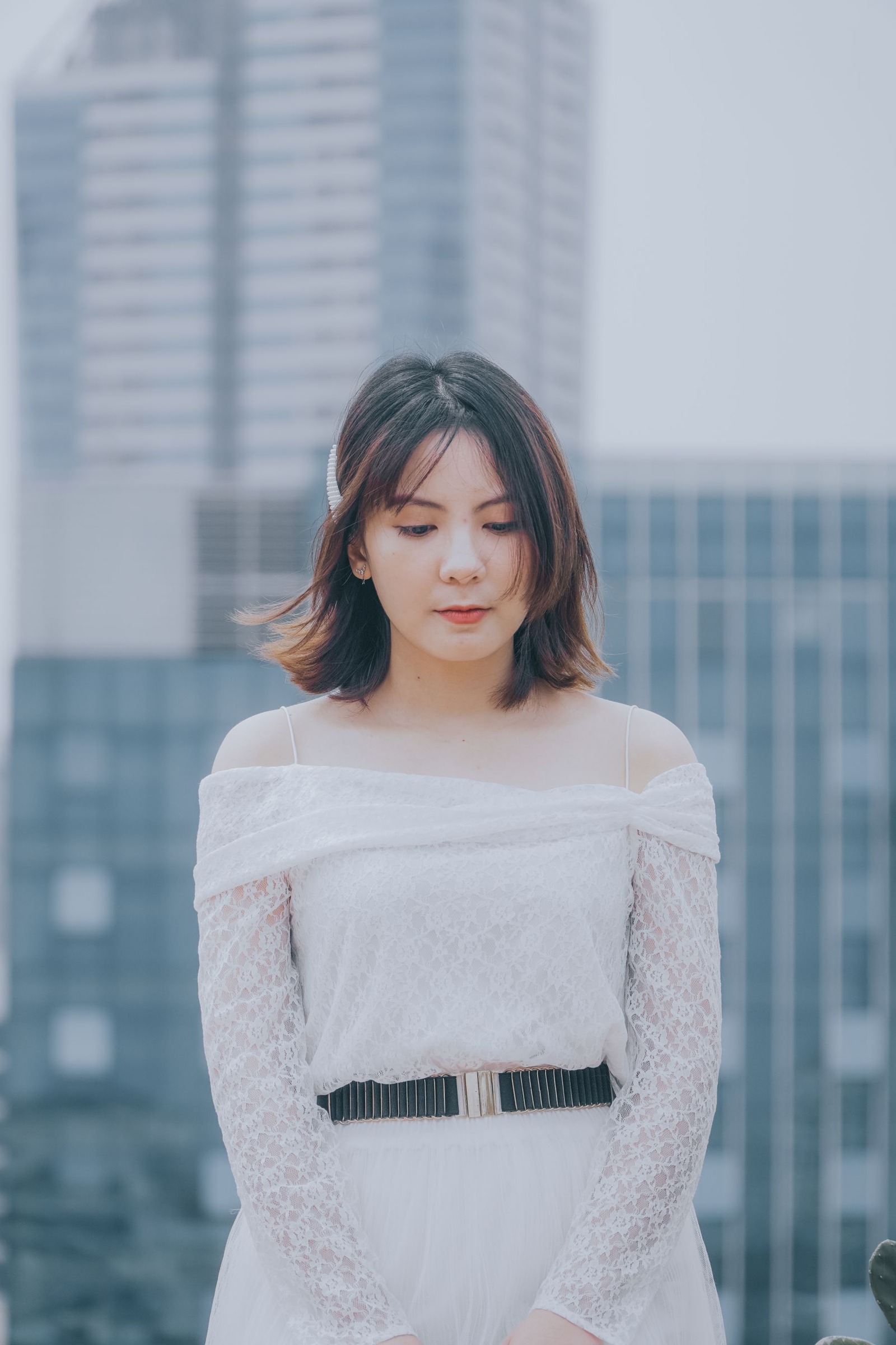 Woman wearing a belt over her dress outdoors