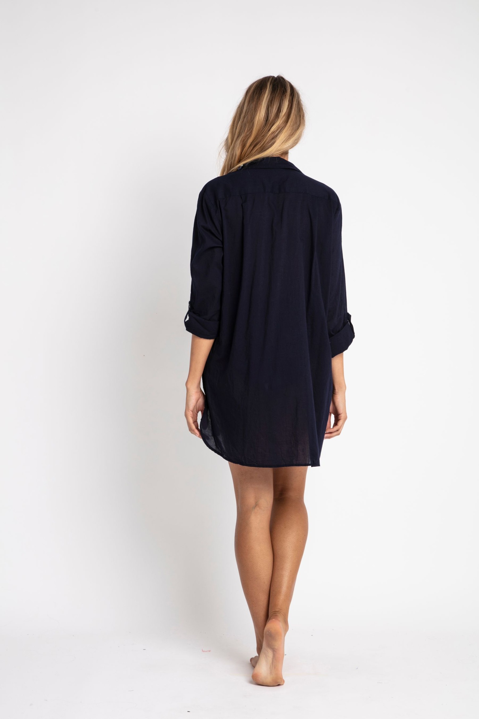 Rear view of a dark Tencel shirt dress against white